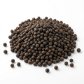 A mound of whole black peppercorns on a clean white background