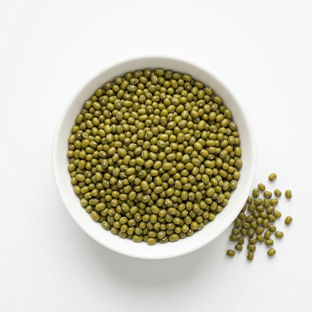 Whole green moong beans in a white porcelain bowl on a white background