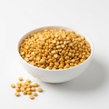 Golden yellow chana dal in a white porcelain bowl on a white background