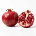 Fresh premium pomegranate whole and cut open showing ruby red arils on white background