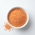 Orange split masoor daal in a white porcelain bowl on a white background