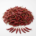 An abundant mound of whole dried red chillies on a clean white background